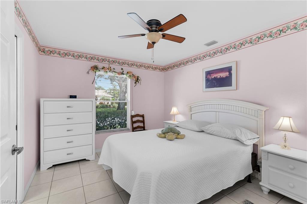 Bedroom with light tile patterned flooring and ceiling fan