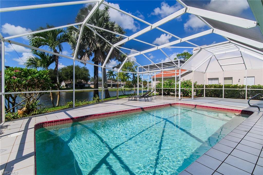 Swimming pool featuring a lanai, a water view, a patio, and a sunroom