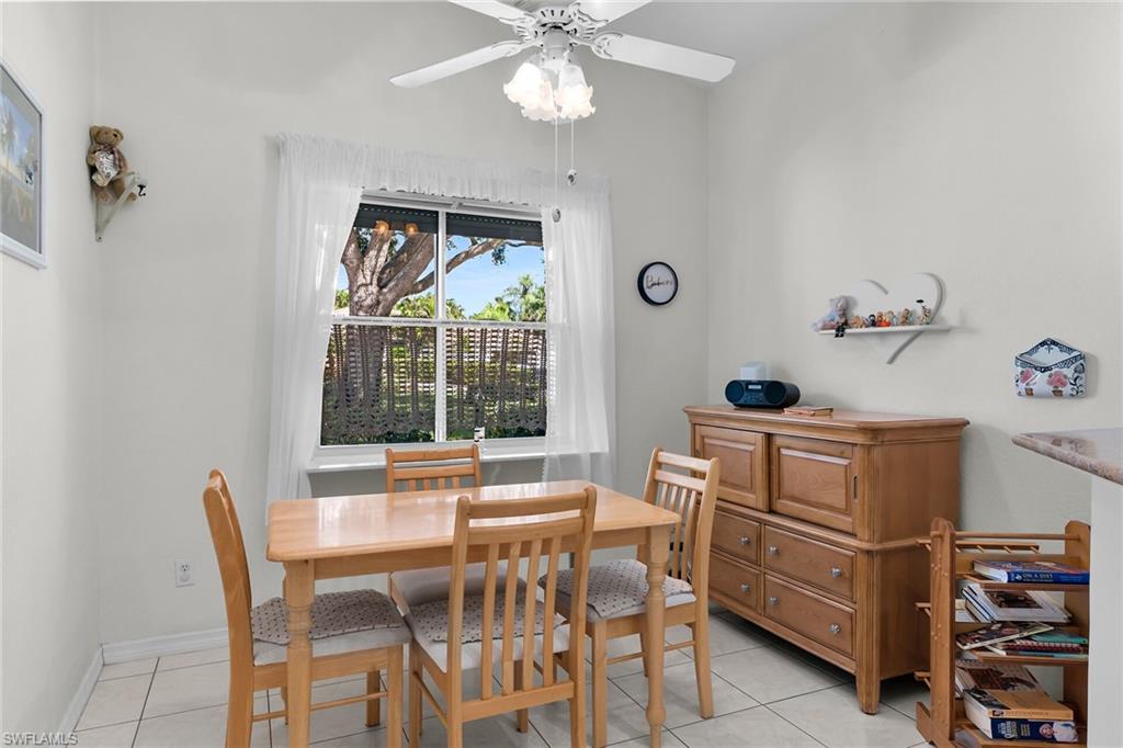 Dining area featuring light tile patterned flooring and ceiling fan