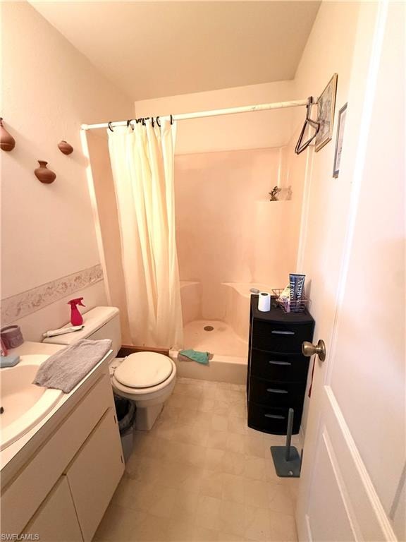 Full bath featuring a stall shower, vanity, and light floors