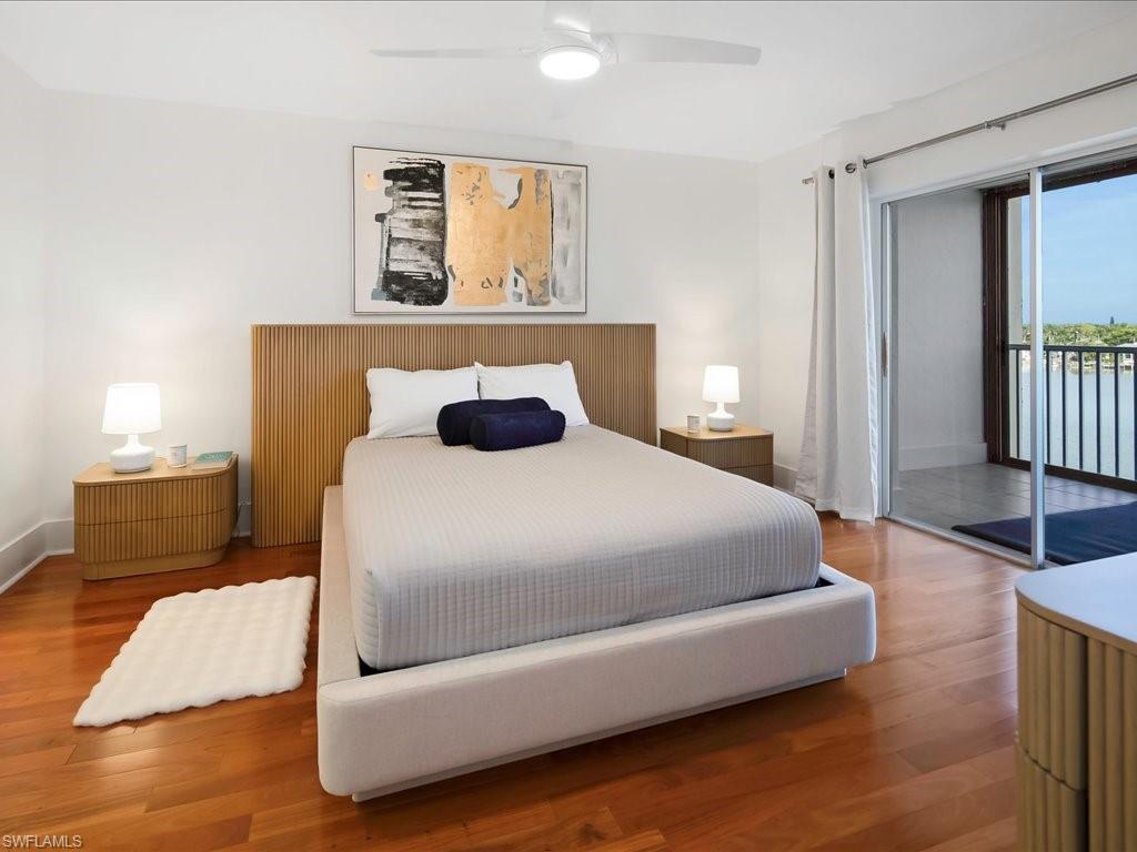 Bedroom with access to exterior, wood finished floors, and a ceiling fan