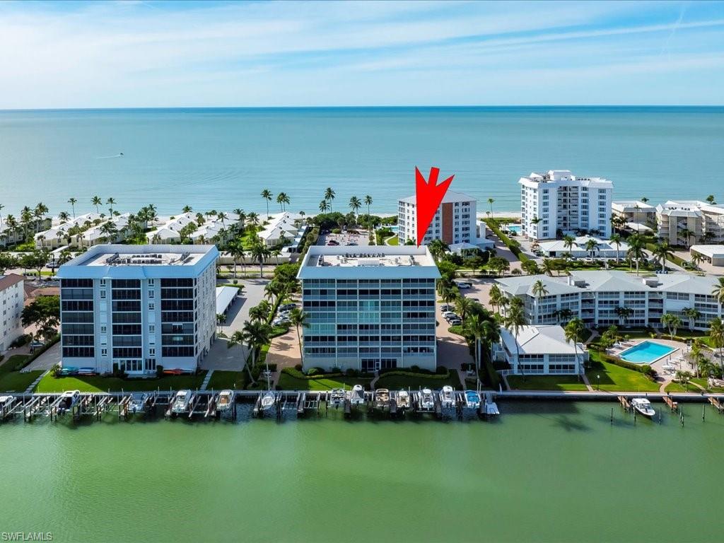 Drone / aerial view of apartment complex / building and a nearby body of water