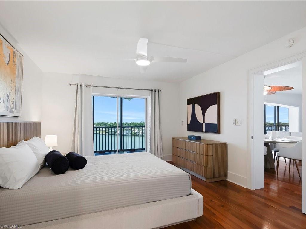 Bedroom featuring dark wood-type flooring, access to exterior, and a ceiling fan