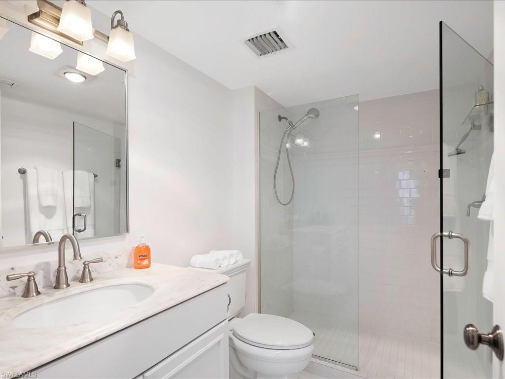Full bathroom with a stall shower and vanity