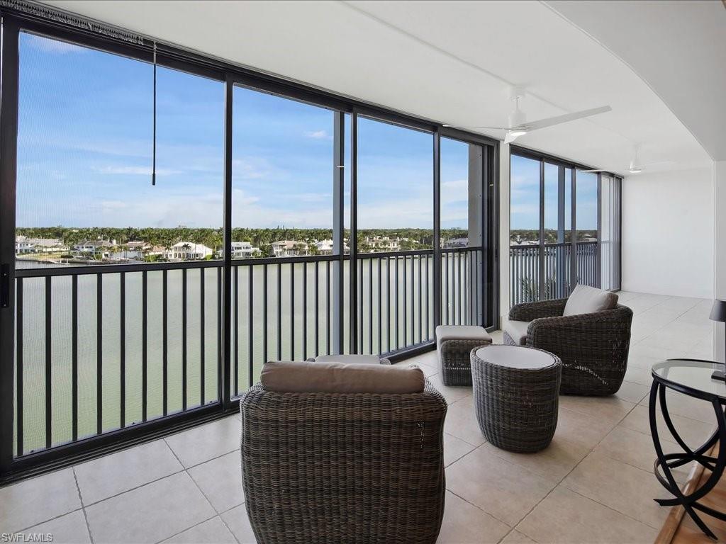 Sunroom / solarium featuring a water view