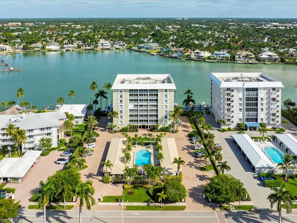 Aerial view of a pool and a large body of water
