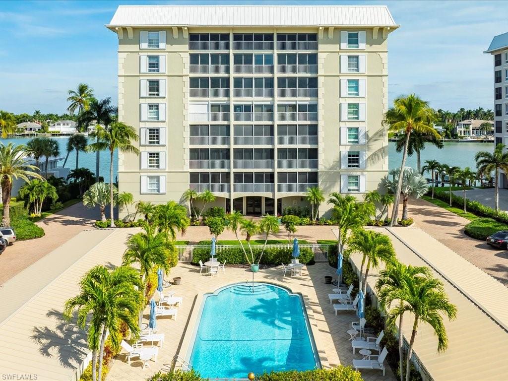 Community pool featuring a water view