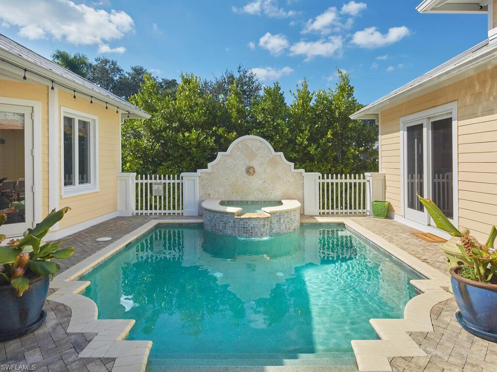 View of swimming pool featuring a patio area and a pool with connected hot tub