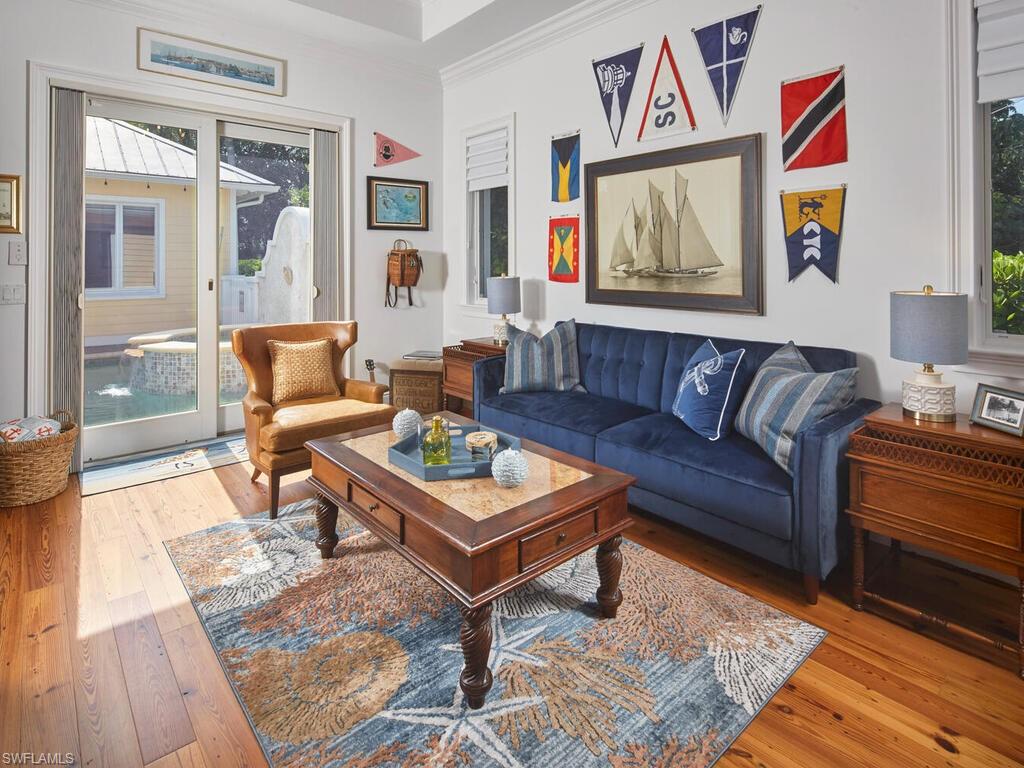 Den area with light wood finished floors and a pull out couch.