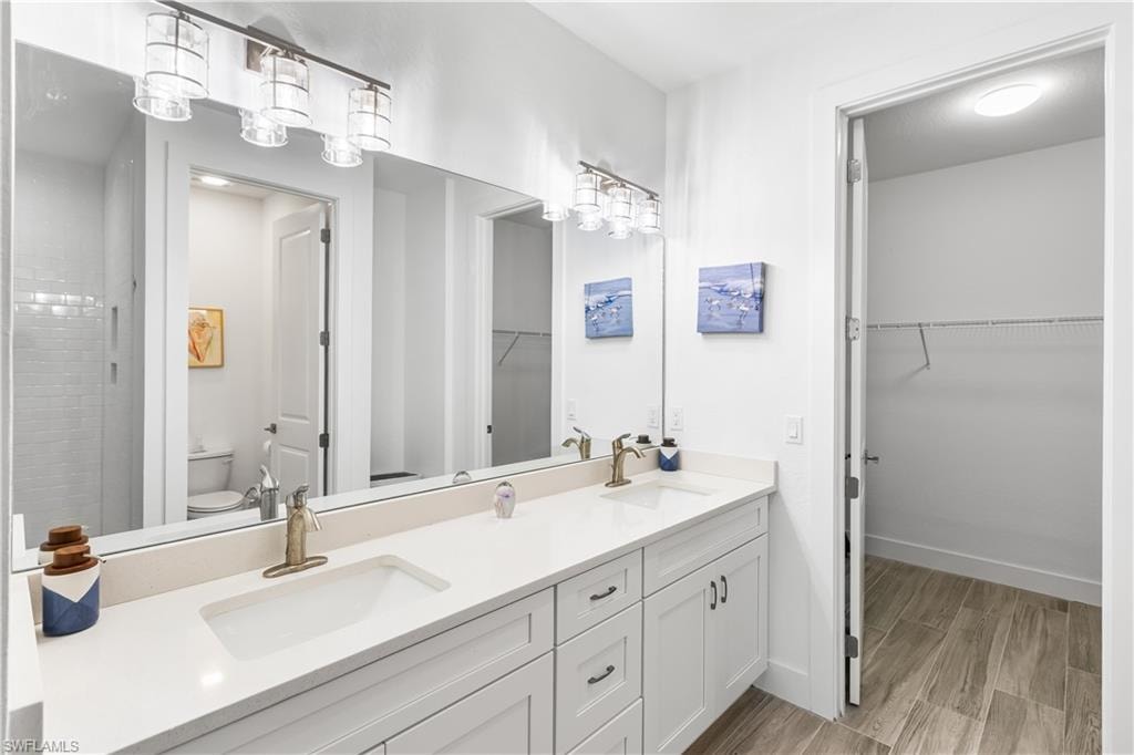 Dual quartz countertop vanitiy. Walk in closet.