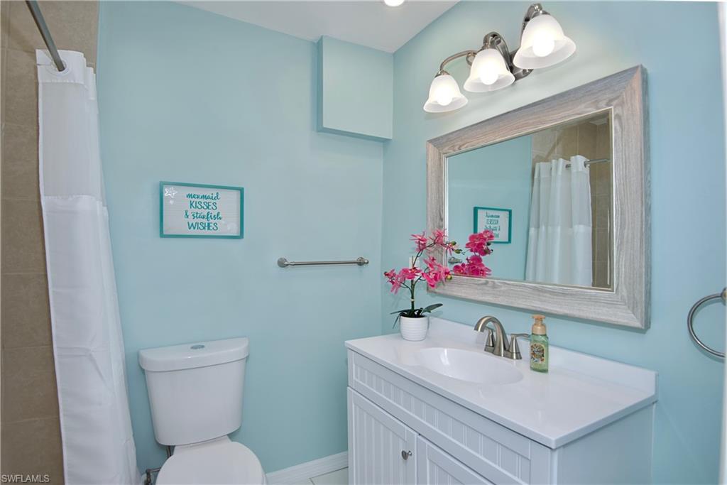 Full bath with vanity and a shower with curtain - Virtually Edited Image