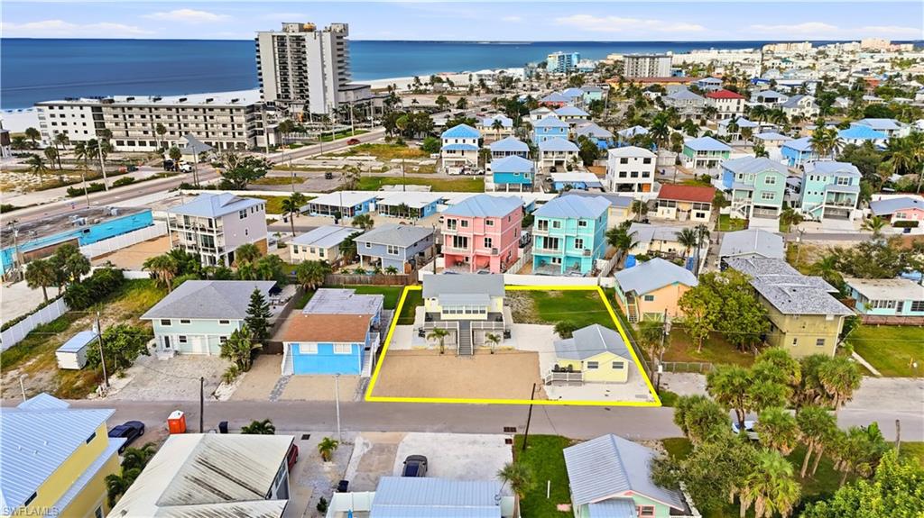 Aerial overview of property's location with property parcel outlined and a nearby body of water - Virtually Edited Image