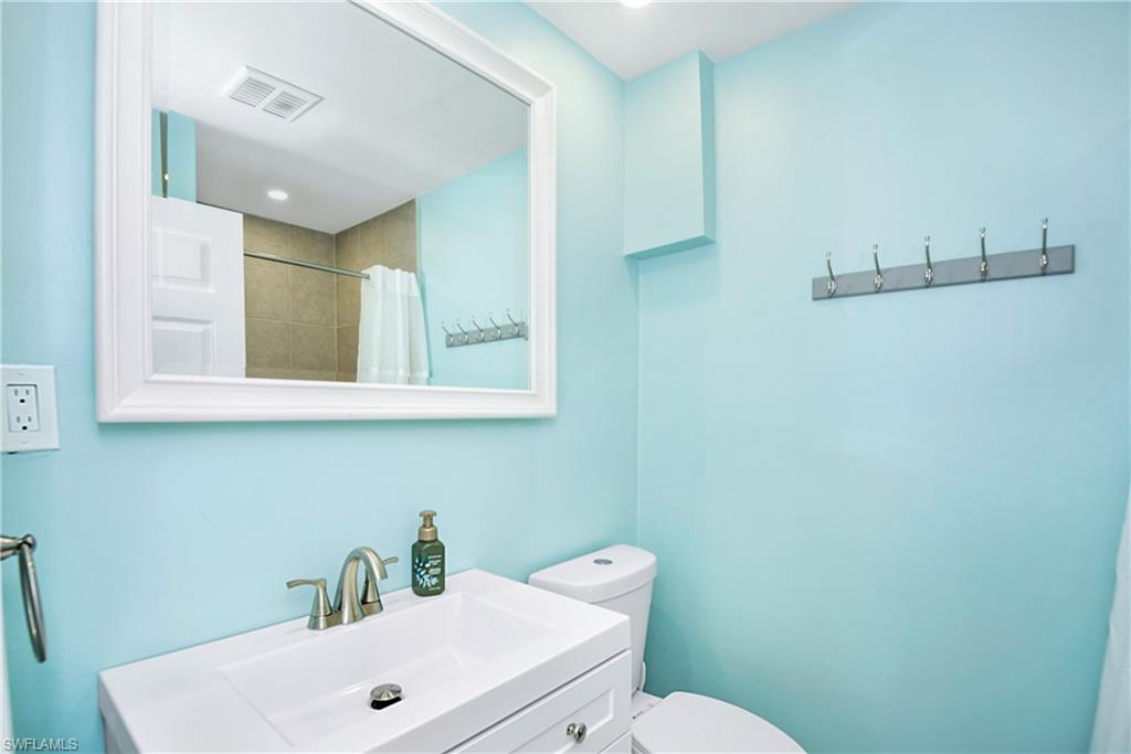 Bathroom with vanity, a shower with shower curtain, and recessed lighting - Virtually Edited Image