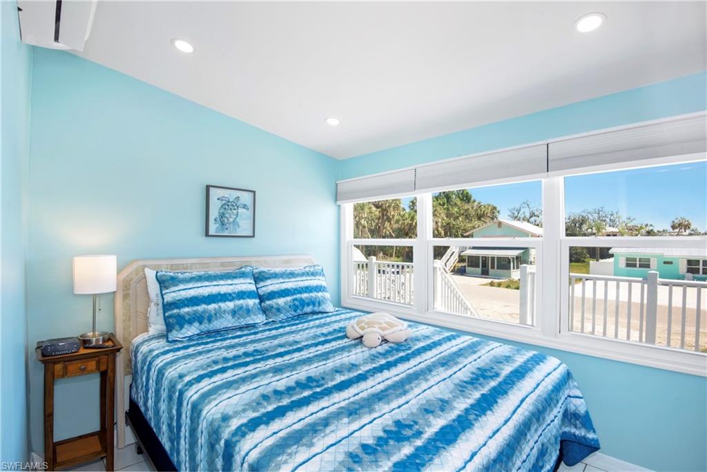 Tiled bedroom with recessed lighting and baseboards - Virtually Edited Image