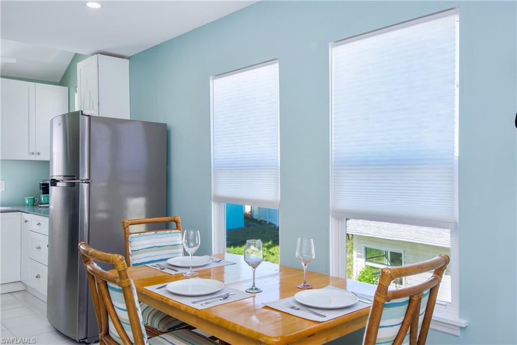 Dining room featuring light tile patterned flooring - Virtually Edited Image