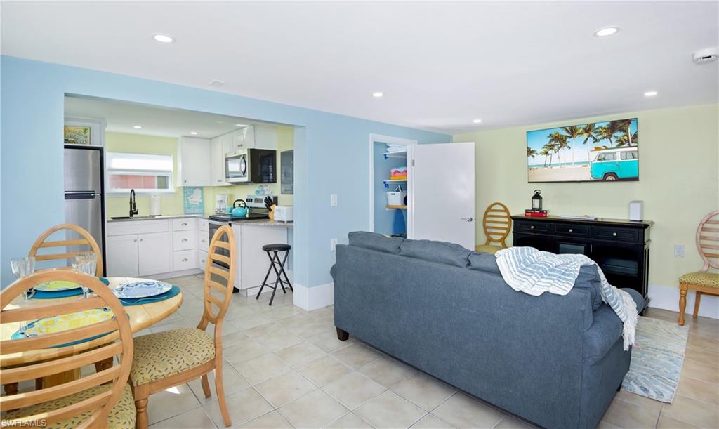 Living room featuring recessed lighting and light tile patterned floors - Virtually Edited Image