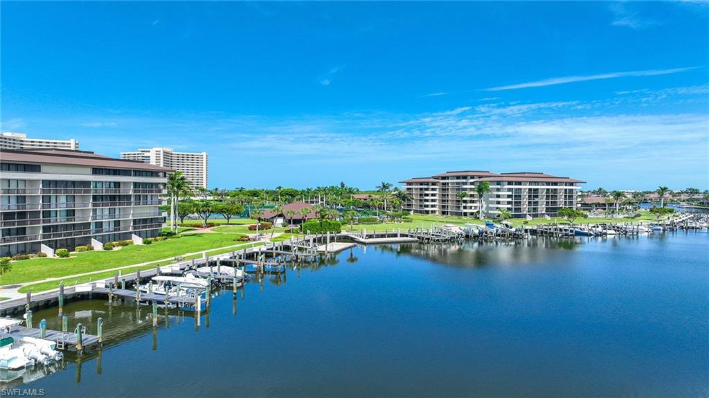 Water view with a floating dock and a marina