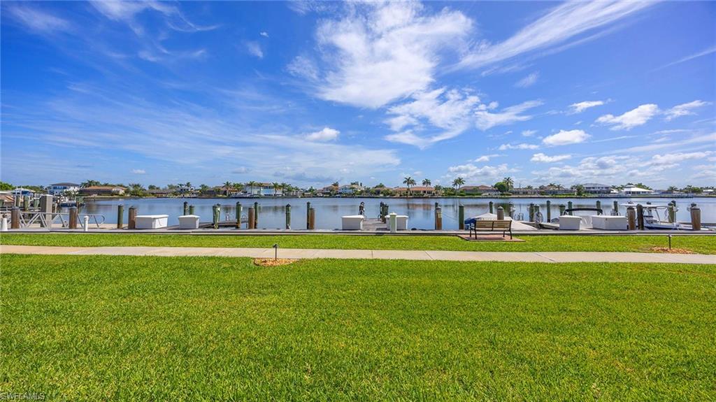 Dock featuring a water view and a lawn