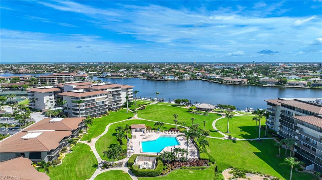 Drone / aerial view of a pool and a large body of water