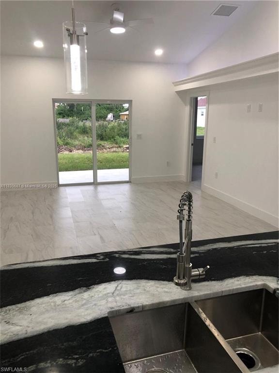 Kitchen with decorative light fixtures and recessed lighting