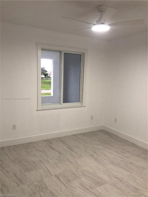 Unfurnished room with baseboards and ceiling fan