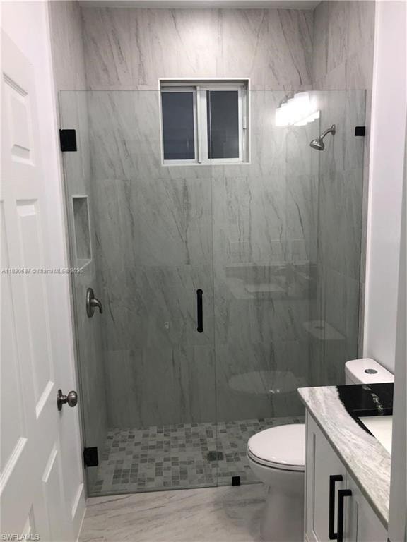 Full bath with vanity and a marble finish shower