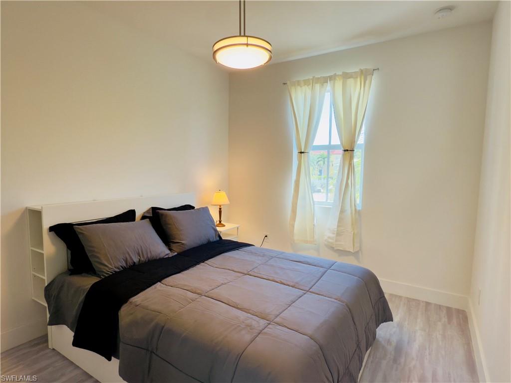 Bedroom featuring baseboards and light wood finished floors