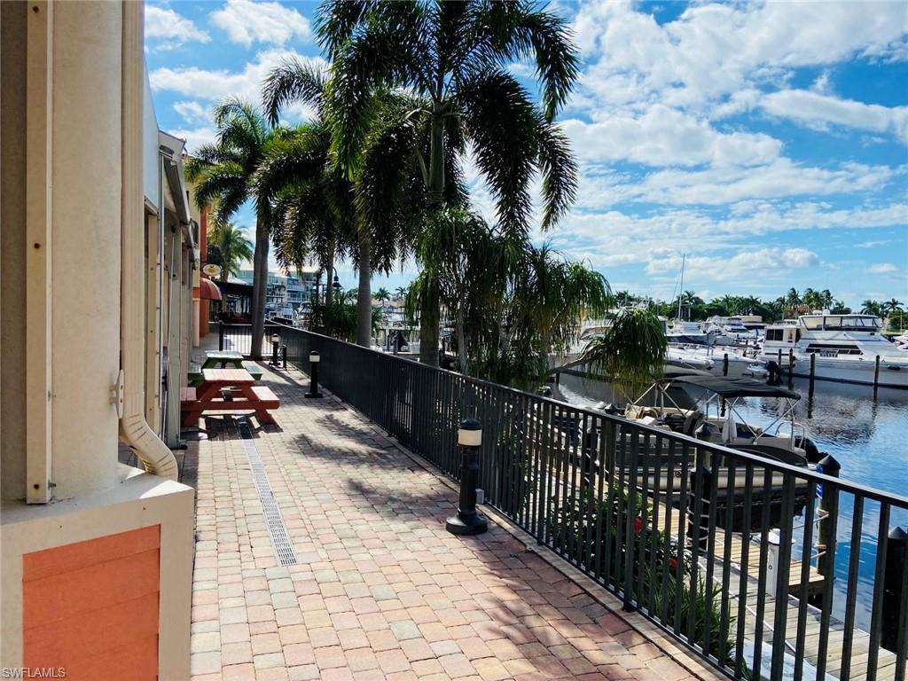 View of patio / terrace with a water view and a boat dock