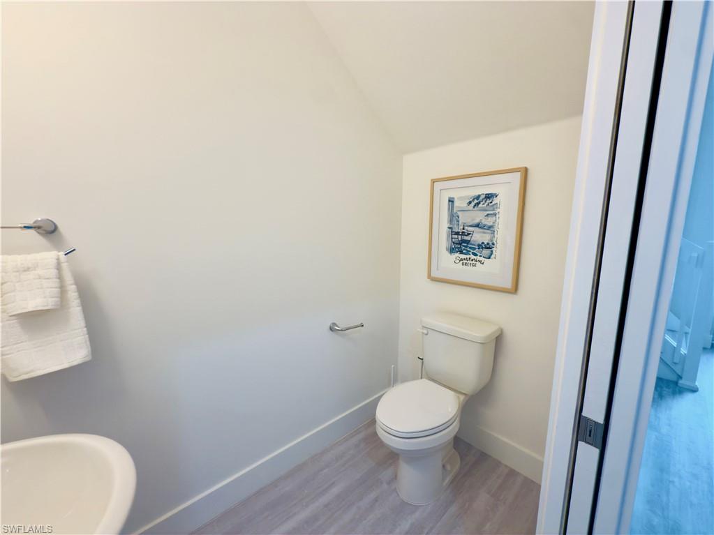 Bathroom with baseboards and wood finished floors