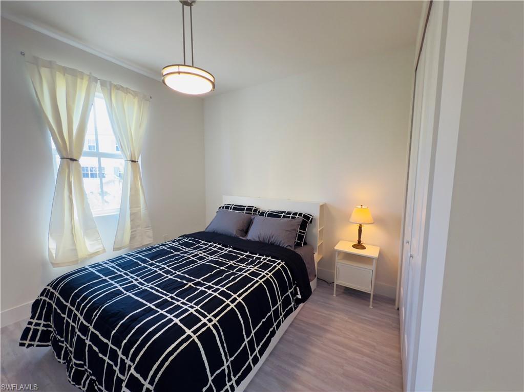 Bedroom featuring wood finished floors and a closet