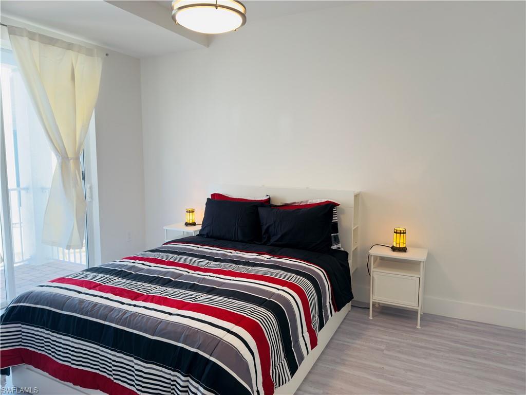 Bedroom featuring wood finished floors and baseboards