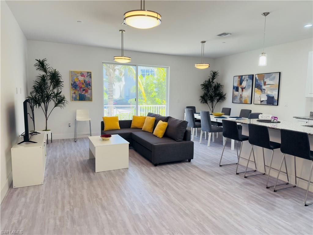 Living room with light wood-type flooring and baseboards