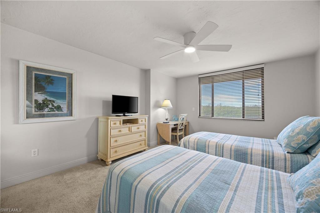 Bedroom with ceiling fan and light colored carpet