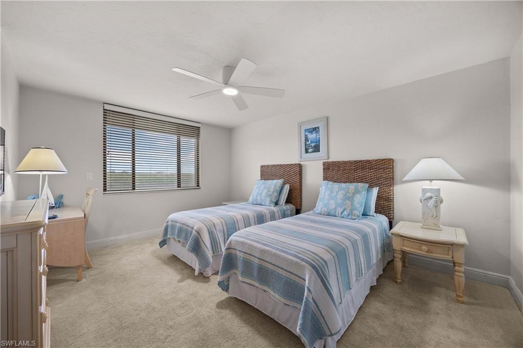 Carpeted bedroom with ceiling fan