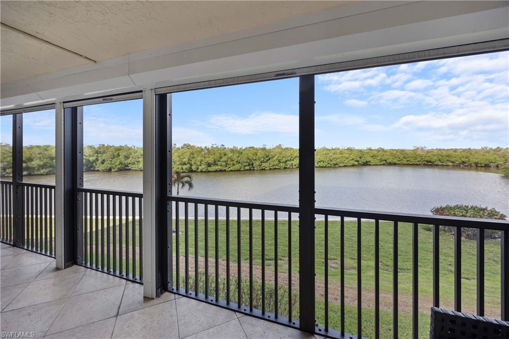Unfurnished sunroom featuring a water view
