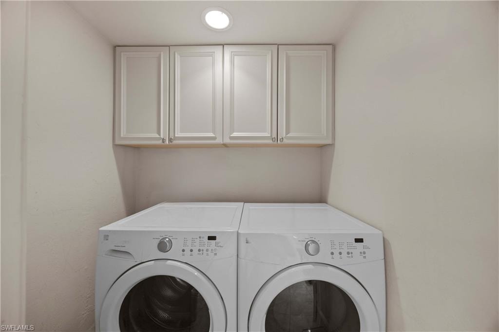 Laundry room with cabinets and washing machine and dryer