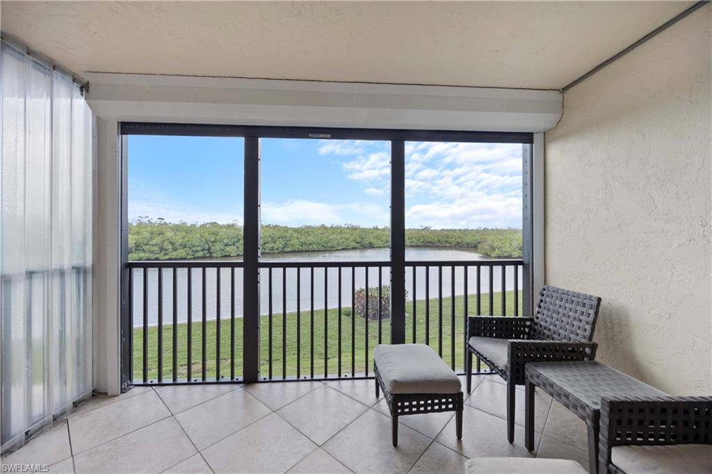 Sunroom featuring a water view