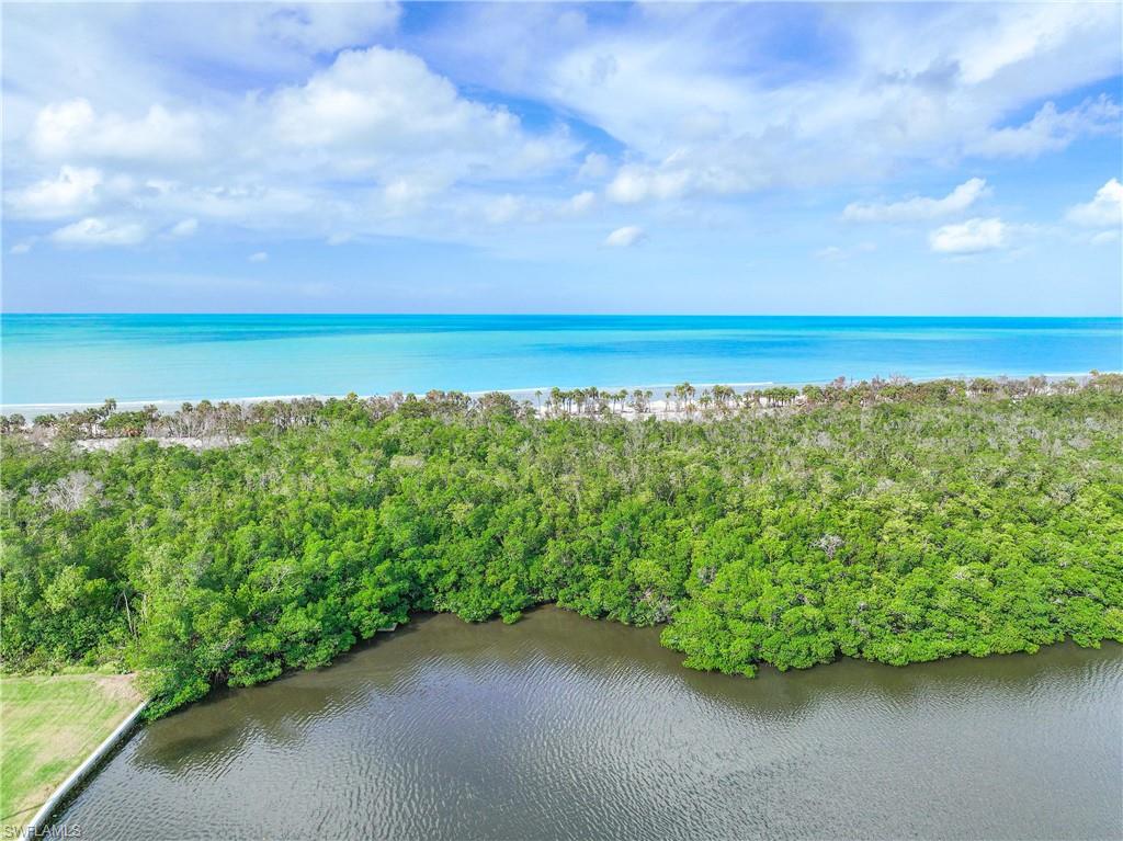 Birds eye view of property with a water view