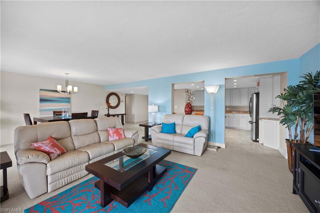 Living room with a chandelier and light colored carpet