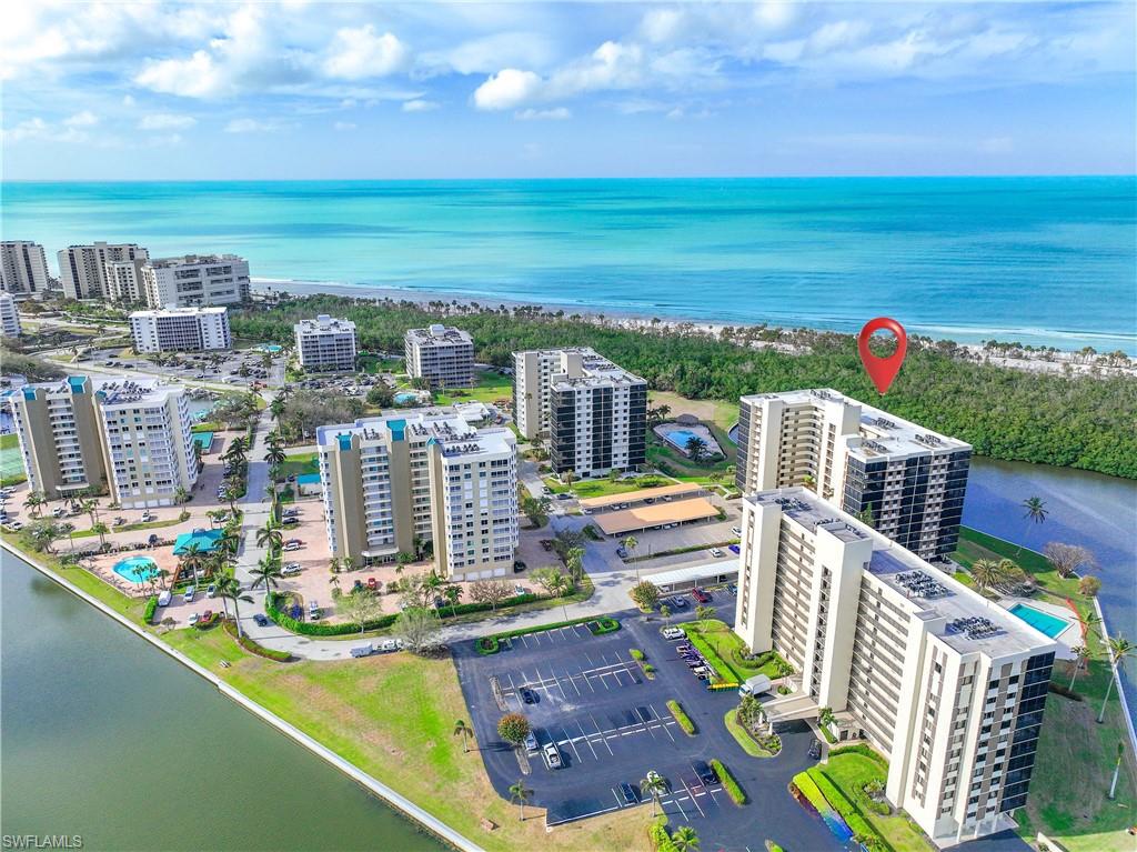 Birds eye view of property with a water view