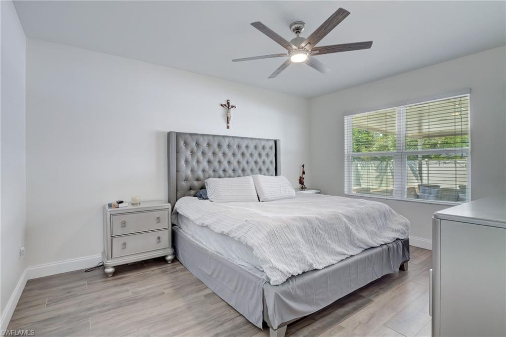 Bedroom featuring wood finished floors and a ceiling fan