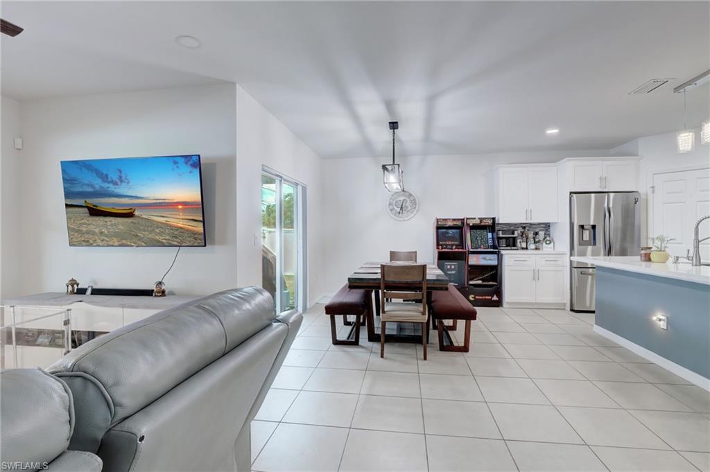 Dining room featuring light tile patterned floors and recessed lighting