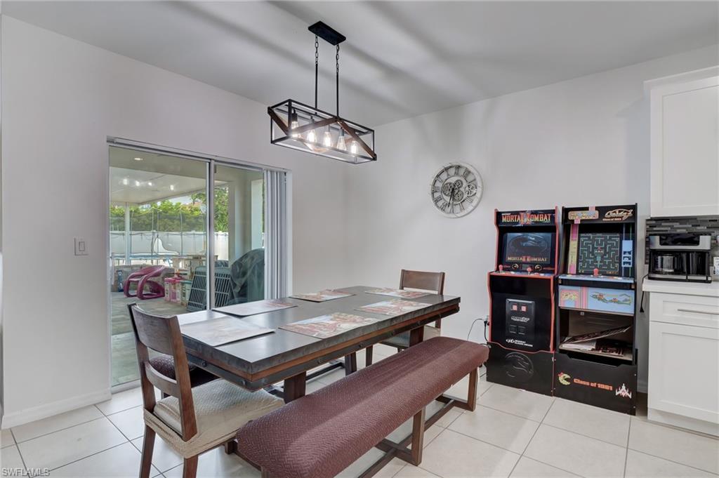 Dining area with light tile patterned flooring