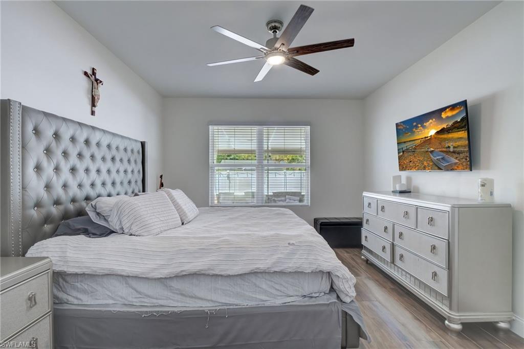 Bedroom featuring dark wood-type flooring and ceiling fan