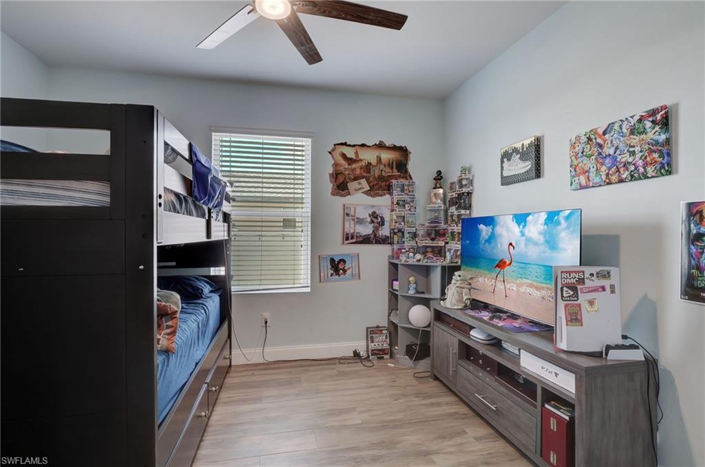 Bedroom featuring light wood-type flooring and a ceiling fan