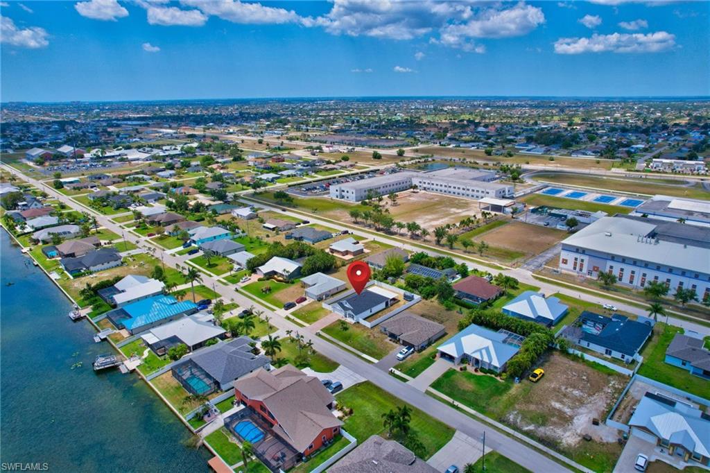 Aerial perspective of suburban area featuring a large body of water