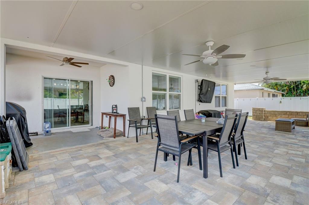View of patio with ceiling fan and outdoor dining area