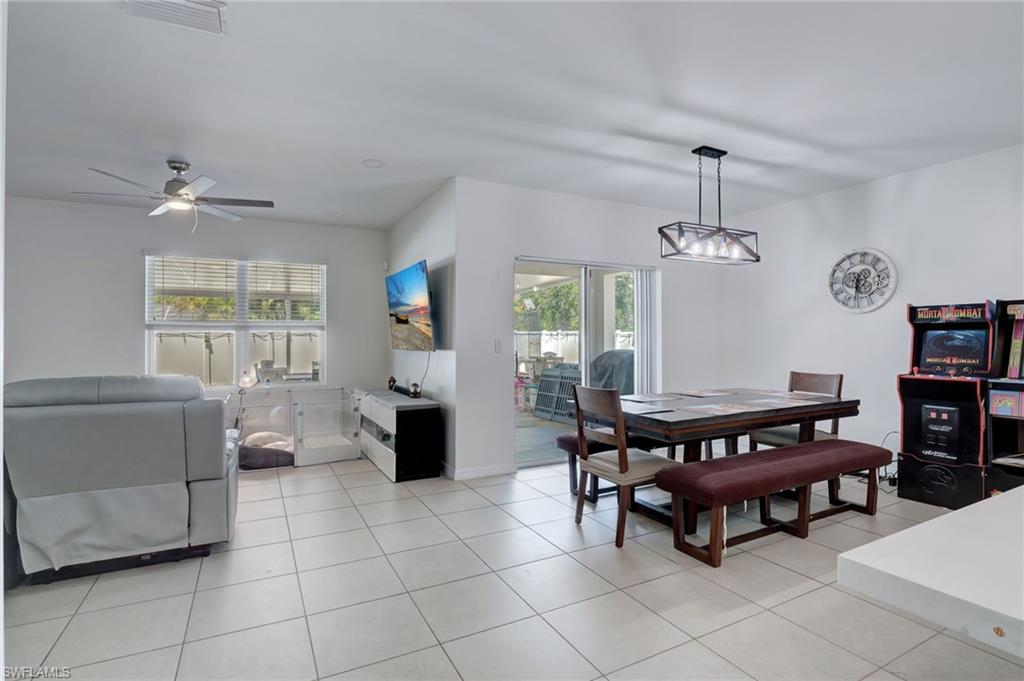 Dining room with light tile patterned floors and a ceiling fan