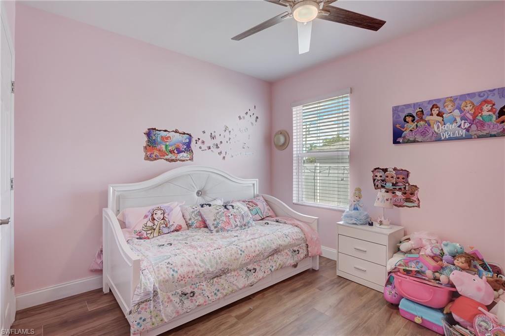 Bedroom featuring wood finished floors and a ceiling fan