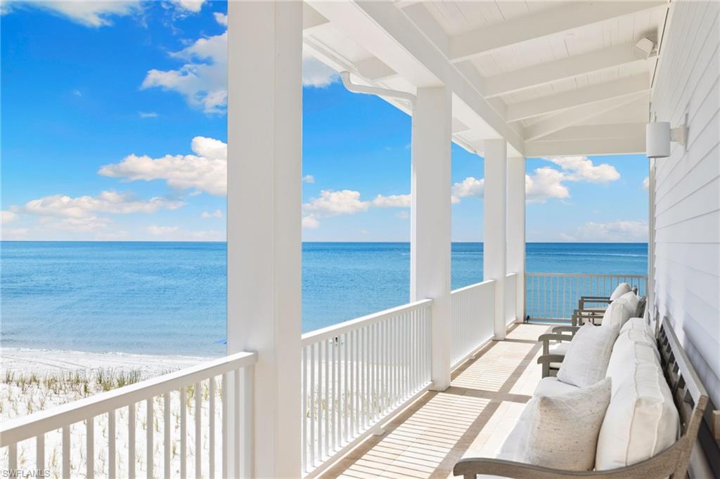 Balcony with view of water and beach